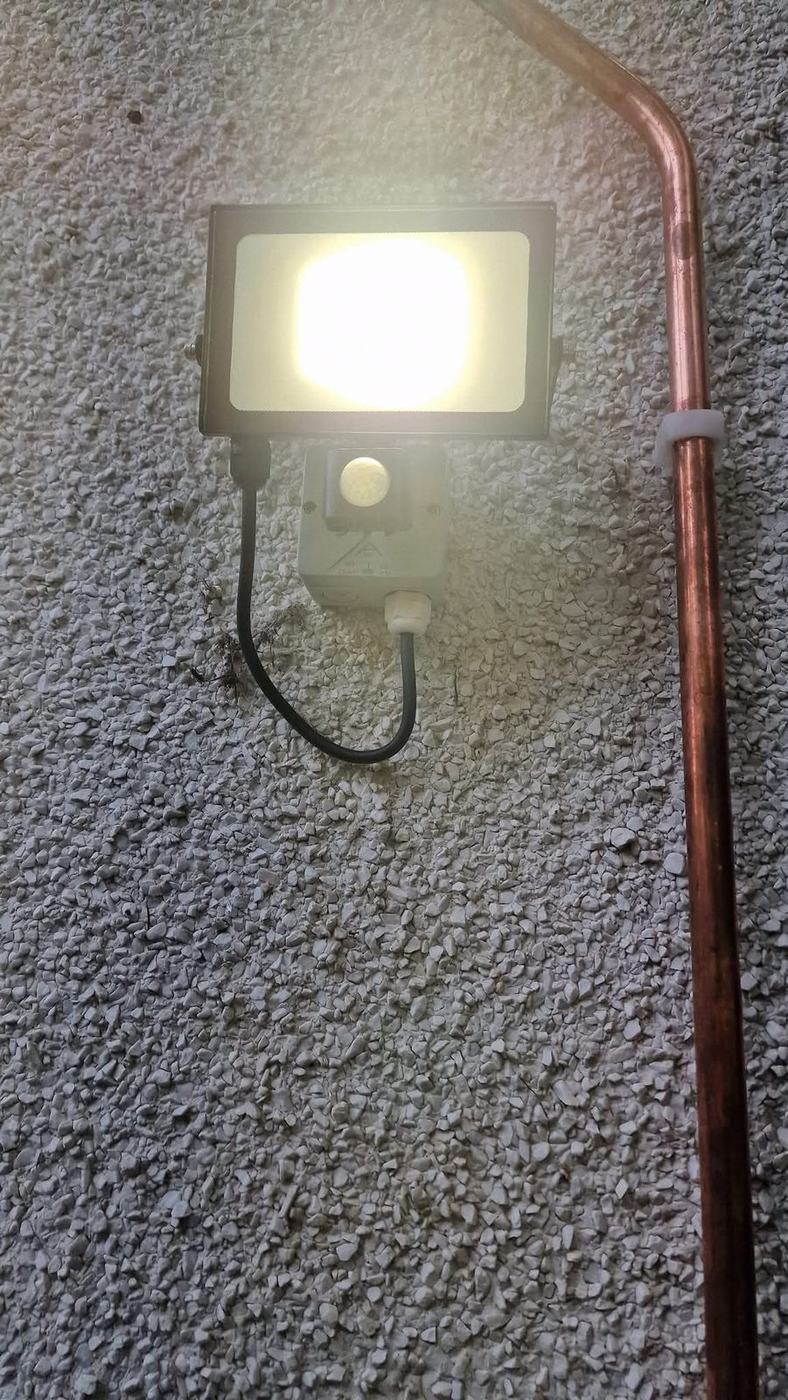 LED security light lit on an exterior wall